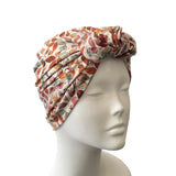 Floral patterned headscarf on a mannequin head against a white background