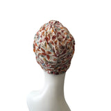 Patterned headscarf on a mannequin head against a white background