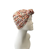 Patterned headscarf on a mannequin head against a white background