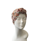 Floral patterned headscarf on a mannequin head against a white background
