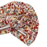Colorful leaf-patterned shower cap on a white background