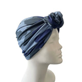 Blue camouflage turban on a mannequin head against a white background