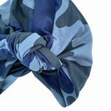Blue and gray patterned headscarf with a knot on a white background