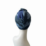Blue patterned headscarf on a mannequin head against a white background