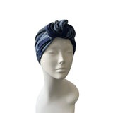 Navy and gray headscarf on a mannequin head against a white background