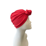 Red headscarf on a mannequin head against a white background
