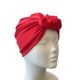 Red headscarf on a mannequin head against a white background