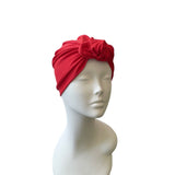 Red headscarf on a mannequin head against a white background