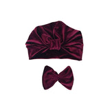 Burgundy velvet headband and bow on a white background