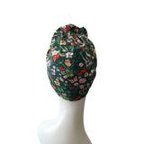 Floral patterned headscarf on a mannequin head against a white background