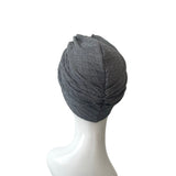 Gray textured headscarf on a mannequin head against a white background