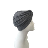 Gray headscarf on a mannequin head against a white background