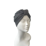 Gray headscarf on a mannequin head against a white background