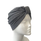 Gray textured headband on a mannequin head against a white background