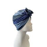 Blue headscarf with a flower on a mannequin head against a white background