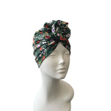 Floral patterned headscarf on a mannequin head against a white background
