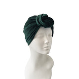 Green headscarf on a mannequin head against a white background