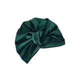 Green satin turban on a white background