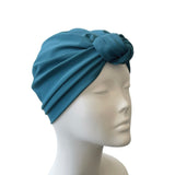 Blue headscarf on a mannequin head against a white background