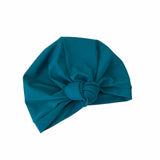 Teal headscarf with a large knot on a white background