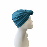 Blue headscarf on a mannequin head against a white background