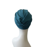 Blue headscarf on a mannequin head against a white background