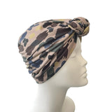 Patterned headscarf on a mannequin head against a white background