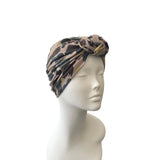 Camouflage-patterned headscarf on a mannequin head against a white background