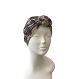 Camouflage-patterned headscarf on a mannequin head against a white background
