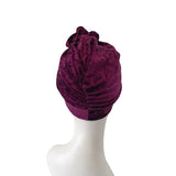 Purple headscarf on a mannequin head against a white background