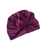 Purple velvet turban with a knot on a white background