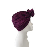 Purple turban on a mannequin head against a white background