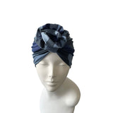 Blue headscarf with floral design on a mannequin head against a white background