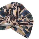 Camouflage-patterned headscarf with a knot on a white background