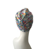 Floral patterned headscarf on a mannequin head against a white background