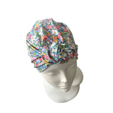 Floral patterned headscarf on a mannequin head against a white background
