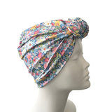 Floral patterned headscarf on a mannequin head against a white background
