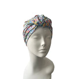 Floral patterned headscarf on a mannequin head against a white background