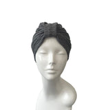 Gray headscarf on a mannequin head against a white background