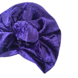 Purple velvet turban with a knot on a white background
