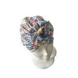 Floral patterned headscarf on a mannequin head against a white background