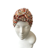 Patterned headscarf on a mannequin head against a white background