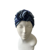 Navy and gray striped headscarf on a mannequin head against a white background