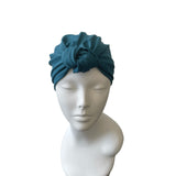 Blue headscarf on a mannequin head against a white background