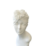White turban on a mannequin head against a white background