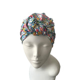 Floral patterned head wrap on a mannequin head against a white background
