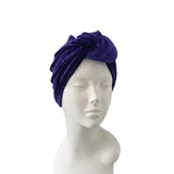 Purple turban on a mannequin head against a white background