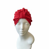 Red headscarf on a mannequin head against a white background