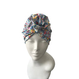 Floral patterned headscarf on a mannequin head against a white background