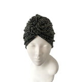 Black textured head wrap on a mannequin head against a white background